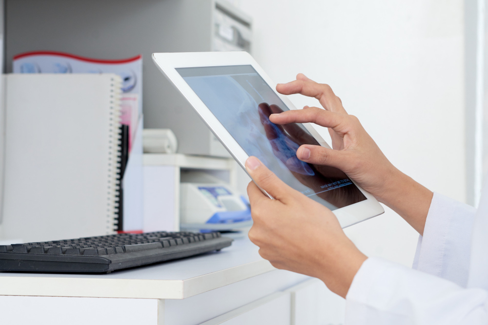 Unrecognizable female doctor with hands on a tablet migration